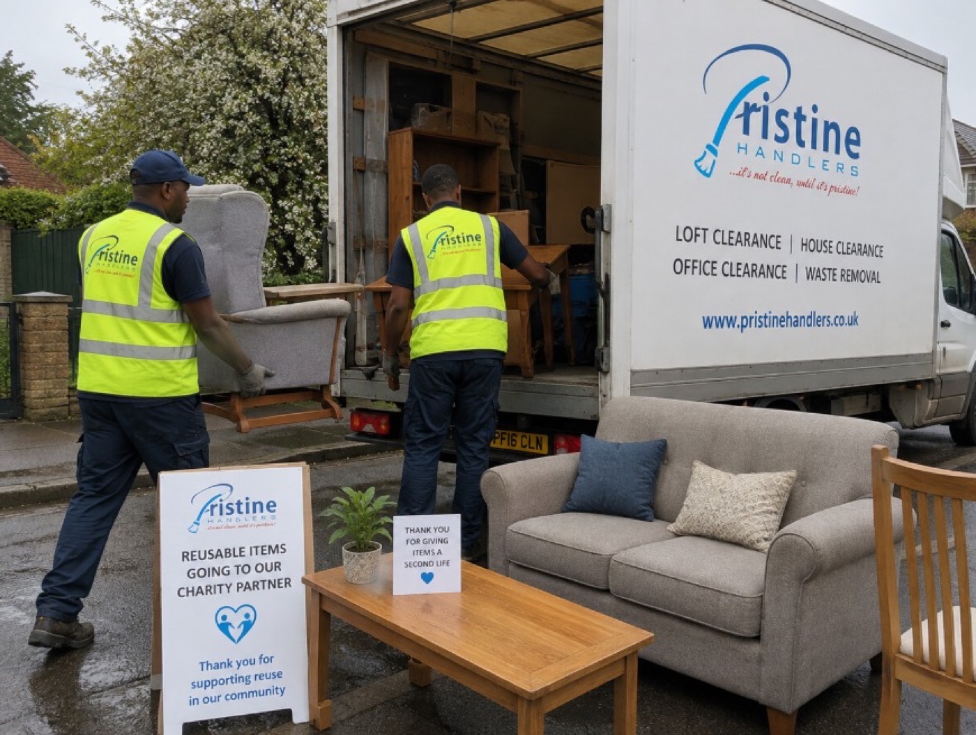 Two crew members loading a sofa and furniture into a Pristine Handlers vehicle